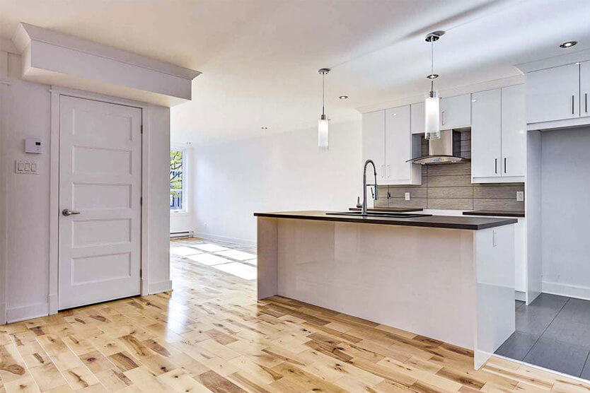 Cuisine rénovée moderne à Montréal avec îlot central et armoires blanches – Honoré-Beaugrand